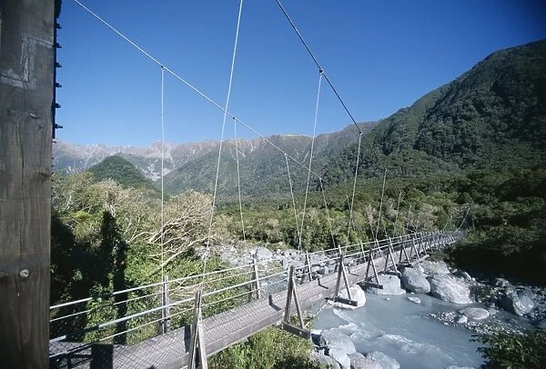 Historic swing bridge over glacier river
