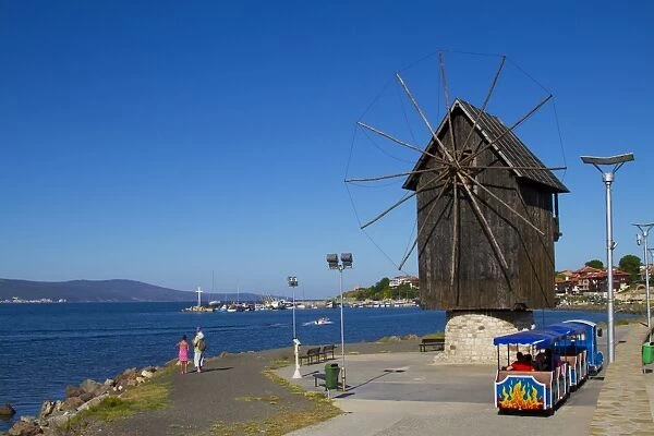 Historical wooden windmill on the Isthmus and small sightseeing tourist train