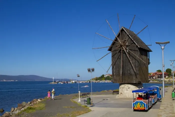 Framed Print : Historical wooden windmill on the Isthmus and small sightseeing tourist train Framed Print : Historical wooden windmill on the Isthmus and small sightseeing tourist train
