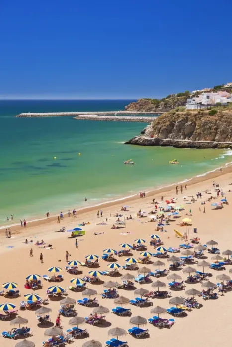 Framed Print : Holidaymakers sunbathing under beach umbrellas on the sandy beach at Praia do Tunel, Albufeira Beach, Algarve, Portugal, Europe Framed Print : Holidaymakers sunbathing under beach umbrellas on the sandy beach at Praia do Tunel, Albufeira Beach, Algarve, Portugal, Europe