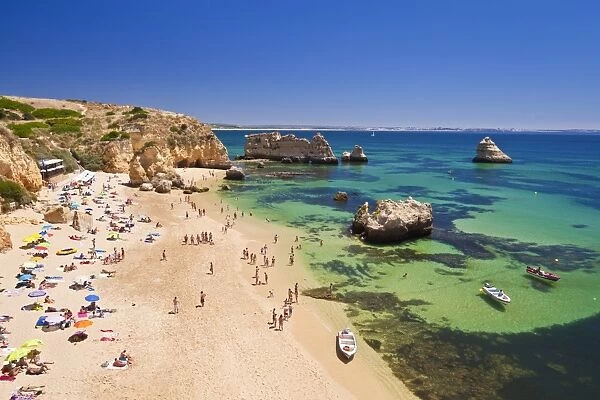 Holidaymakers sunbathing on Praia da Dona Ana, sandy beach near the resort of Lagos, Algarve, Portugal, Europe