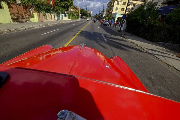 The hood of a vintage car driving the streets of Havana, Havana, Cuba, West Indies
