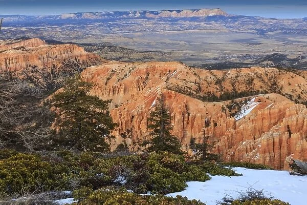 Hoodoos, vegetation and snow with a distant view on a winters late afternoon, Bryce Point, Bryce Canyon National Park, Utah, United States of America, North America