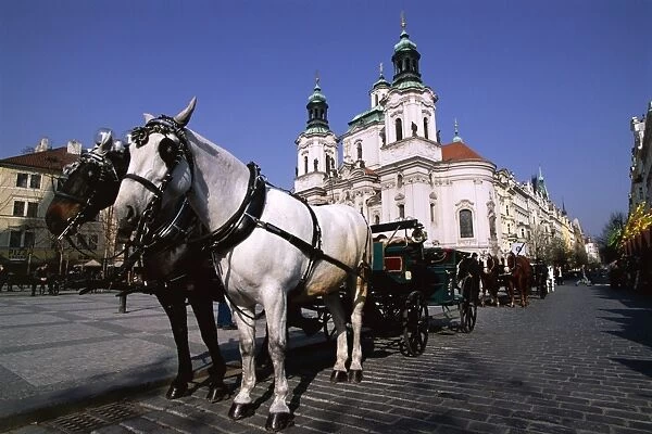 Horse and carriage and church of St. Nicholas, Old Town Square, Prague