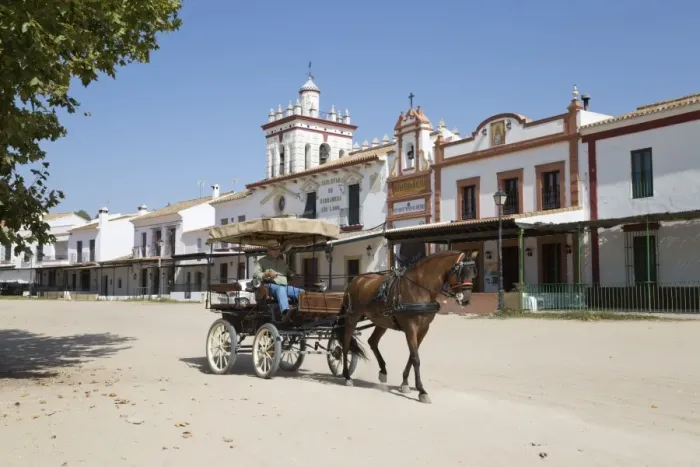 Framed Print : Horse and carriage riding along sand streets with brotherhood houses behind, El Rocio Framed Print : Horse and carriage riding along sand streets with brotherhood houses behind, El Rocio