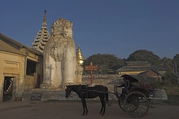 Horse and cart beside lion statue at the entrance to the Shwezigon Paya