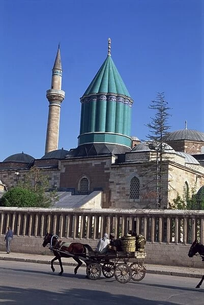 Horse and cart passes the Mevlana Tekke Museum with