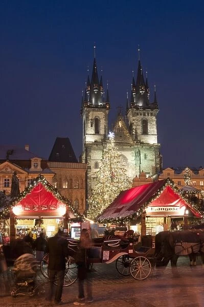 Horse drawn carriage at Christmas Market and Gothic Tyn Church at twilight