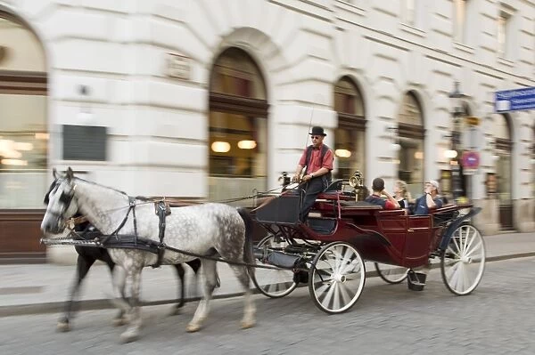 Horse-drawn tourist carriage near Hofburg, Vienna, Austria, Europe