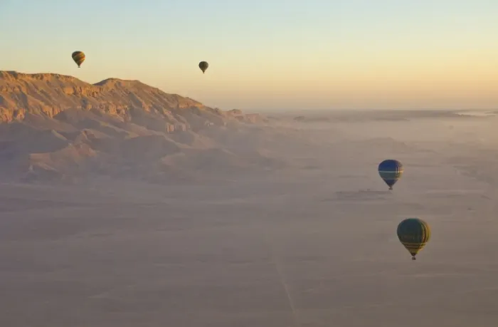 Framed Print : Hot air balloons on an excursion flying over the desert early morning at dawn Framed Print : Hot air balloons on an excursion flying over the desert early morning at dawn