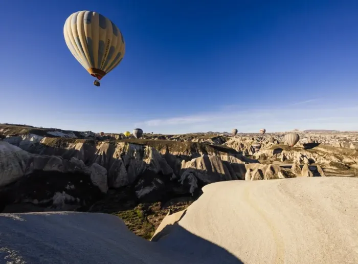 Framed Print : Hot air balloons flying among rock formations at sunrise in the Red Valley, Goreme National Park Framed Print : Hot air balloons flying among rock formations at sunrise in the Red Valley, Goreme National Park