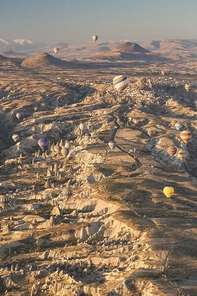 Hot air balloons rising into the dawn sky above Goreme, Cappadocia, Anatolia, Turkey, Asia Minor, Eurasia