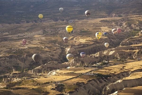 Hot air balloons above the volcanic landscape near Goreme, Cappadocia, Anatolia, Turkey, Asia Minor, Eurasia