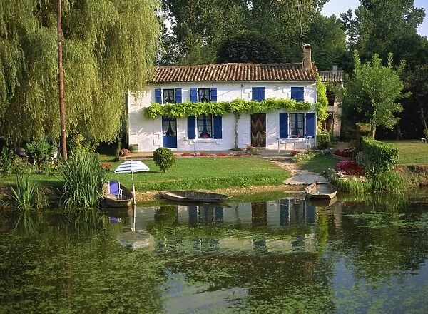 House with pond in garden, Coulon, Marais Poitevin, Poitou Charentes, France, Europe