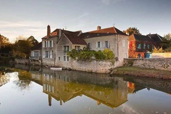 A house reflecting in the River Serein in the village of Noyers-sur-Serein, Yonne, Burgundy, France, Europe