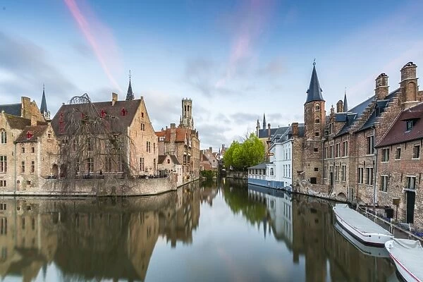 House reflections and boats on Dijver canal at dawn, Bruges, West Flanders province