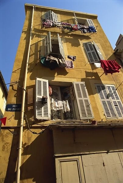 House with shutters and washing lines on the Rue du Panier, in the old town in Marseille