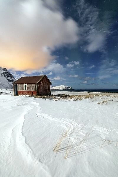 House surrounded by snow in a cold winter day, Flakstad, Lofoten Islands, Arctic