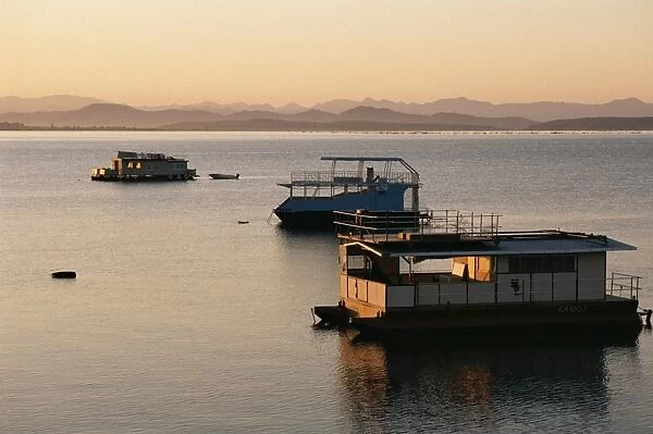 Houseboats at dawn at Cutty Sark Hotel marina, Lake Kariba, Zimbabwe, Africa
