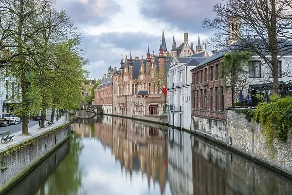Houses and bridge reflected in the Groenerei canal, Bruges, West Flanders province