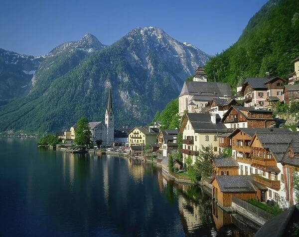 Houses, chalets and the church of the village of Hallstatt beside the lake