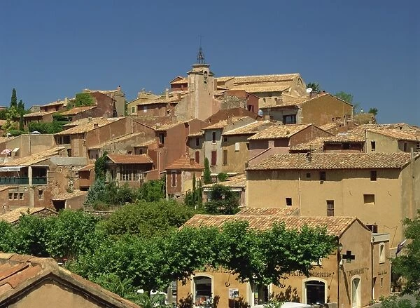 Houses and church tower on the skyline in the village of Roussillon, Vaucluse