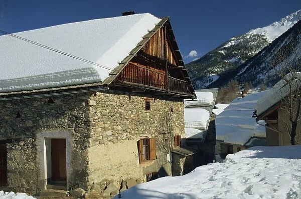 Houses covered in snow in the village of Nevache near Briancon, French Alps