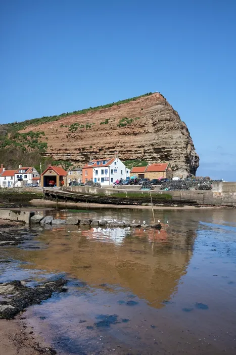 Framed Print : Houses nestled under the high cliffs in the small fishing village of Staithes, Yorkshire, United Kingdom Framed Print : Houses nestled under the high cliffs in the small fishing village of Staithes, Yorkshire, United Kingdom