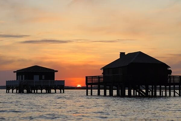 Houses on stilts at sunset, Bay of Arcachon, Gironde, Aquitaine, France, Europe