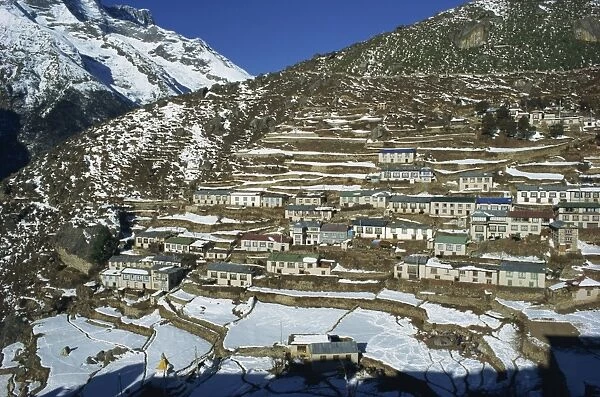 Houses and terraced fields under snow at Namche Bazaar
