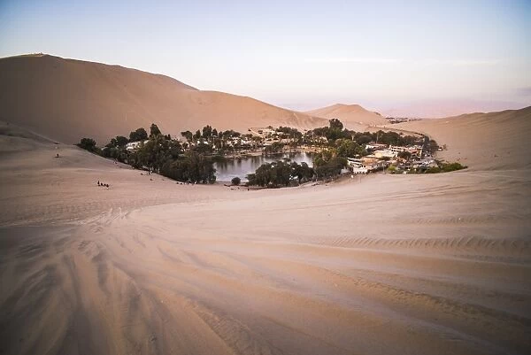 Huacachina and sand dunes at sunset in the desert in the Ica Region, Peru, South America