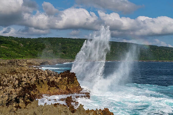 Huge blowhole on the rugged coast of Christmas Island, Australia, Indian Ocean
