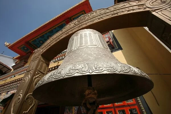 A huge Tibetan bell hangs outside a temple in Bodinath, Kathmandu, Nepal, Asia