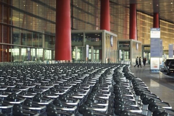 Hundreds of trolleys at Beijing Capital Airport, part of the new Terminal 3 building opened February 2008, second largest building in the world, Beijing