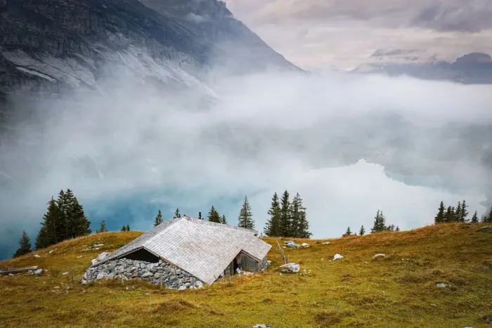 Framed Print : Hut on mountain ridge above lake Oeschinensee covered by mist, Bernese Oberland Framed Print : Hut on mountain ridge above lake Oeschinensee covered by mist, Bernese Oberland