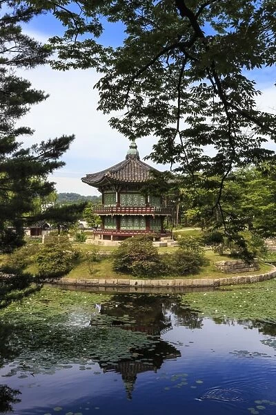 Hyangwonjeong, hexagonal pavilion reflected in water lily filled lake in summer