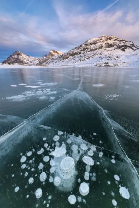 Framed Print : Ice bubbles frame the snowy peaks reflected in Lago Bianco, Bernina Pass, canton of Graubunden Framed Print : Ice bubbles frame the snowy peaks reflected in Lago Bianco, Bernina Pass, canton of Graubunden