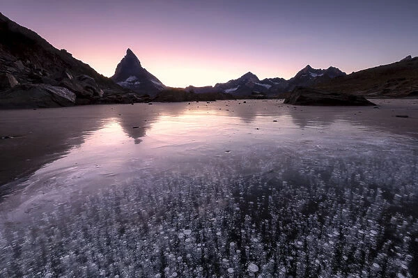 Ice bubbles in the Riffelsee Lake during sunset. Zermatt, Mattertal, Canton of Valais