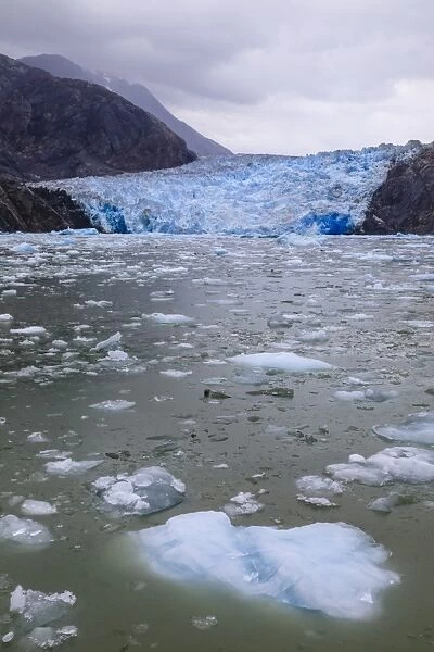 Ice pack and blue ice face of South Sawyer Glacier, mountain backdrop, Stikine Icefield