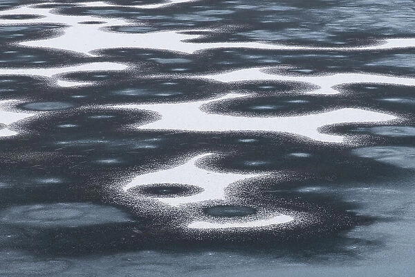 Ice Patterns on frozen Llyn y Dywarchen in winter, Snowdonia National Park (Eryri), North Wales, United Kingdom, Europe