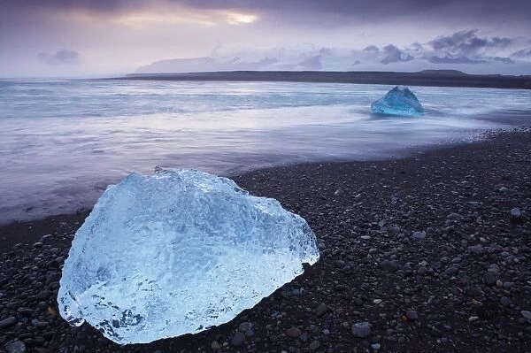 Iceberg washed ashore on Breidamerkursandur black sands, near Jokulsarlon glacial lagoon