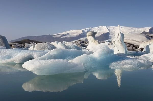 Icebergs in Jokulsarlon glacial lagoon, Oraefajokull glacier in the distance