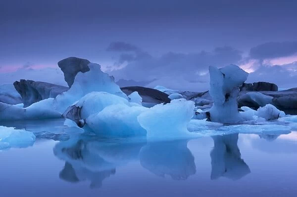 Icebergs in Jokulsarlon glacial lagoon, at dusk, East Iceland, Iceland, Polar Regions