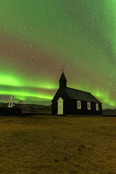Iconic black wooden Budakirkja church under the Northern Lights (Aurora Borealis), Budir, Snaefellsness Peninsula, Vesturland, Iceland, Polar Regions