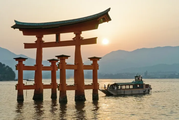 Framed Print : The iconic torii and a tourist cruise boatat the Itsukushima Shrine, on Miyajima island, hiroshima Prefecture, Japan