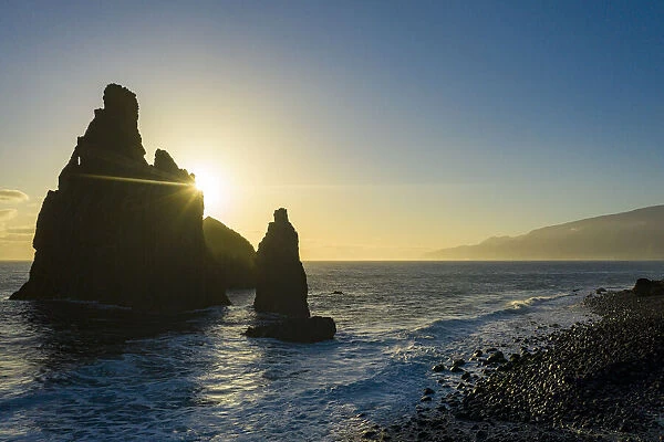 Ilheus da Rib and Ribeira da Janela rock formations lit by sun rays at dawn