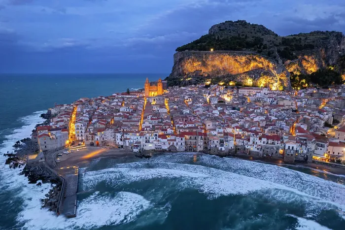 Framed Print : The illuminated fishing village of Cefalu with the rock on top of the old town seen from the drone at dusk, Cefalu, Palermo province, Tyrrhenian Sea, Sicily, Italy, Mediterranean, Europe