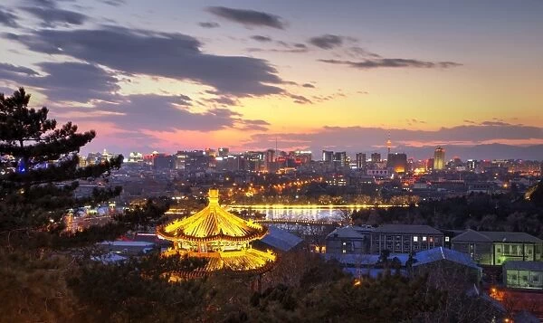 Illuminated pagoda and view towards the western part of Beijing city at nightfall
