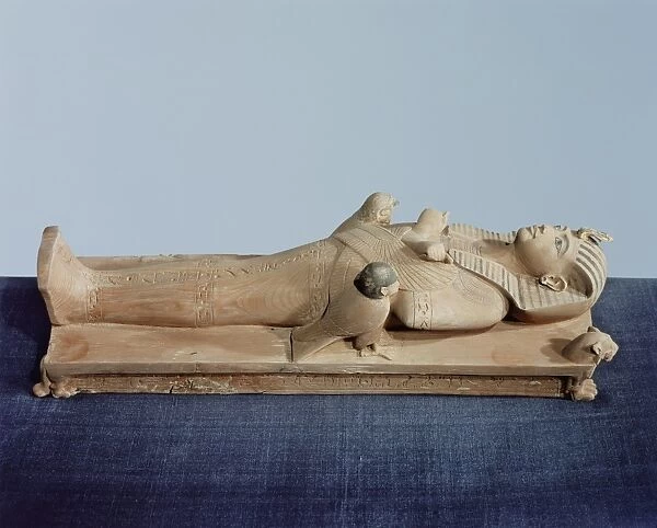 Image of the kings mummy on its funeral bed flanked by the kings two souls