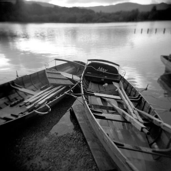 Image taken with a Holga medium format 120 film toy camera of two old boats by lake side